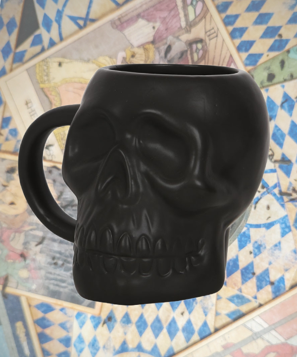 matte black skull mug on its side