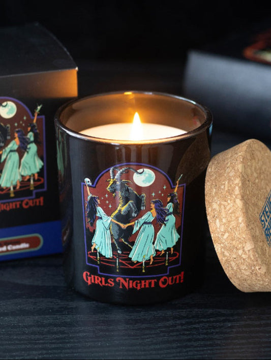Candle with 'Girls Night Out' design and cork lid on a dark surface